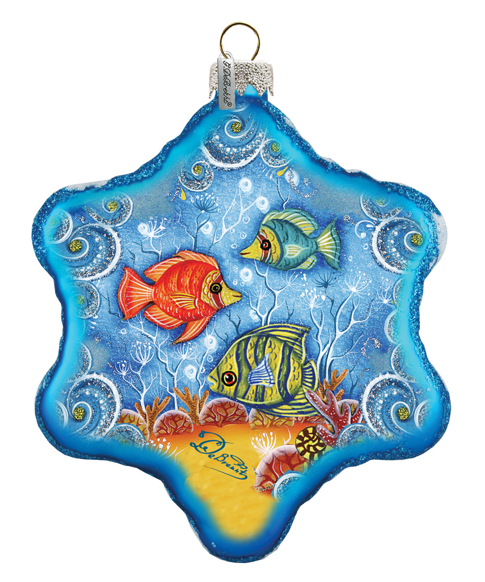 a glass ornament with two fish on it