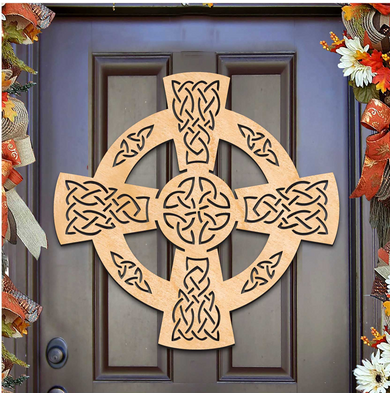 a wooden cross-shaped decoration hanging on a door.