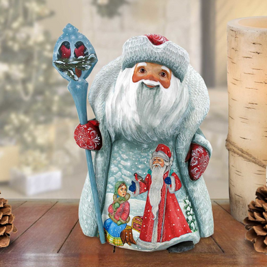 A figurine of Santa Claus holding a blue staff and a bird, with a snowy winter scene depicted on the front.