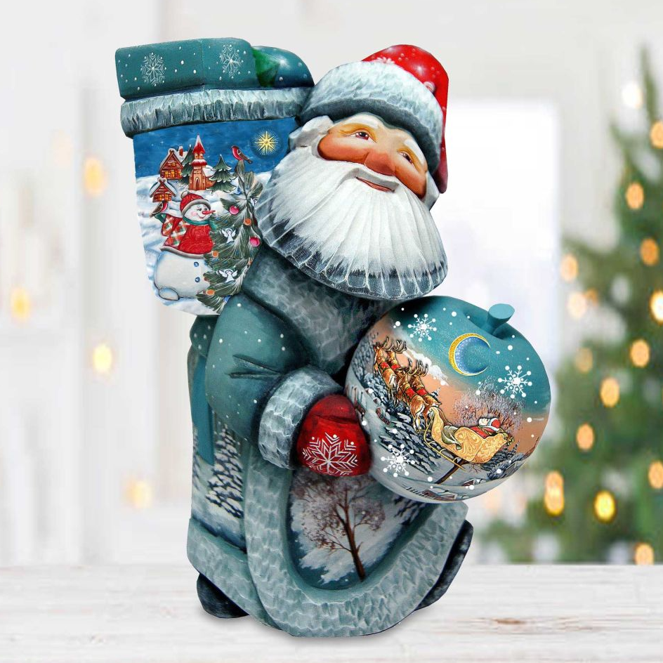 A figurine of Santa Claus holding a snowman and a Christmas ornament, set against a blurred background with Christmas lights.