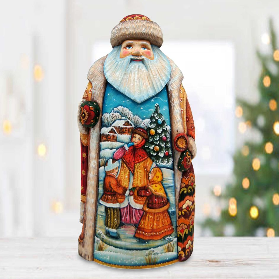 A colorful, hand-painted figurine of Santa Claus, featuring a winter scene with people, a Christmas tree, and other festive elements.