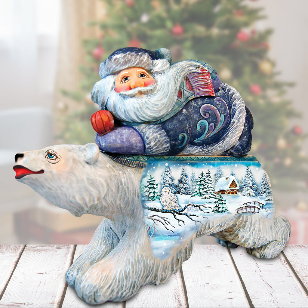 a statue of santa claus sitting on top of a polar bear
