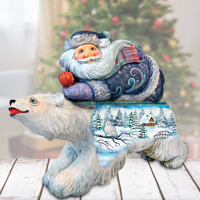 a statue of santa claus sitting on top of a polar bear