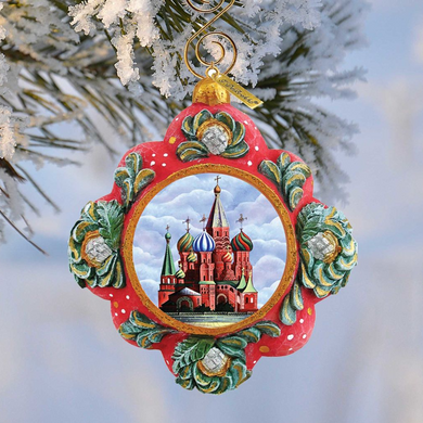 A decorative ornament featuring a painting of St. Basil's Cathedral in Moscow, Russia, hanging from a tree branch.