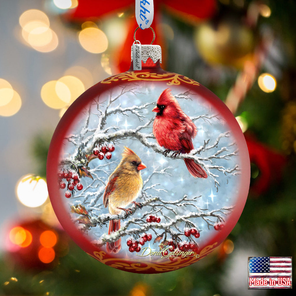 a christmas ornament with a cardinal and a cardinal on it