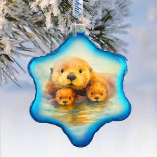 A blue star-shaped ornament with a painting of a mother otter and her two cubs.