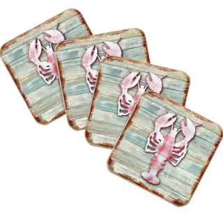 four square coasters with a lobster design on a wooden background.