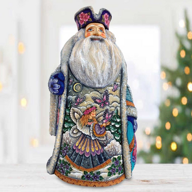 A colorful, intricately designed figurine of Santa Claus, featuring a detailed and vibrant design with various elements such as flowers, butterflies, and a moon.