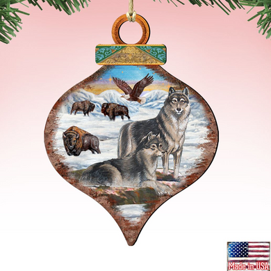 a decorative ornament with a painting of a wolf, a bear, and a bison in a snowy landscape, along with an eagle in the background.
