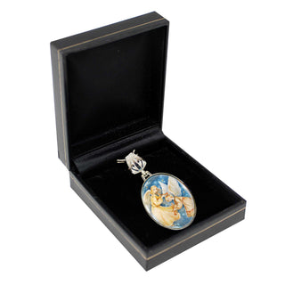A pendant with a floral design is displayed in a black jewelry box.