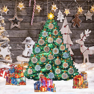 The image is a festive Christmas scene with a large, brightly lit green Christmas tree surrounded by colorful presents, ornaments, and decorations. The tree is set against a backdrop of a wooden wall with stars and a gingerbread man.