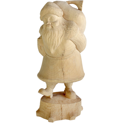 A carved wooden figure of Santa Claus carrying a sack on his back, standing on a wooden stump.