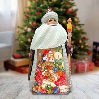 A large, colorful Christmas ornament depicting Santa Claus holding a lit candle and surrounded by various holiday decorations, including a decorated Christmas tree in the background.