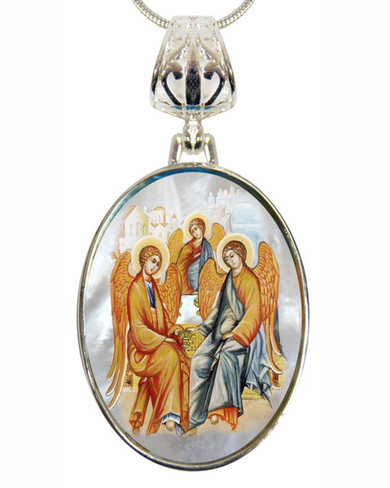 a pendant with a religious icon of three angels, one of whom is holding a book.