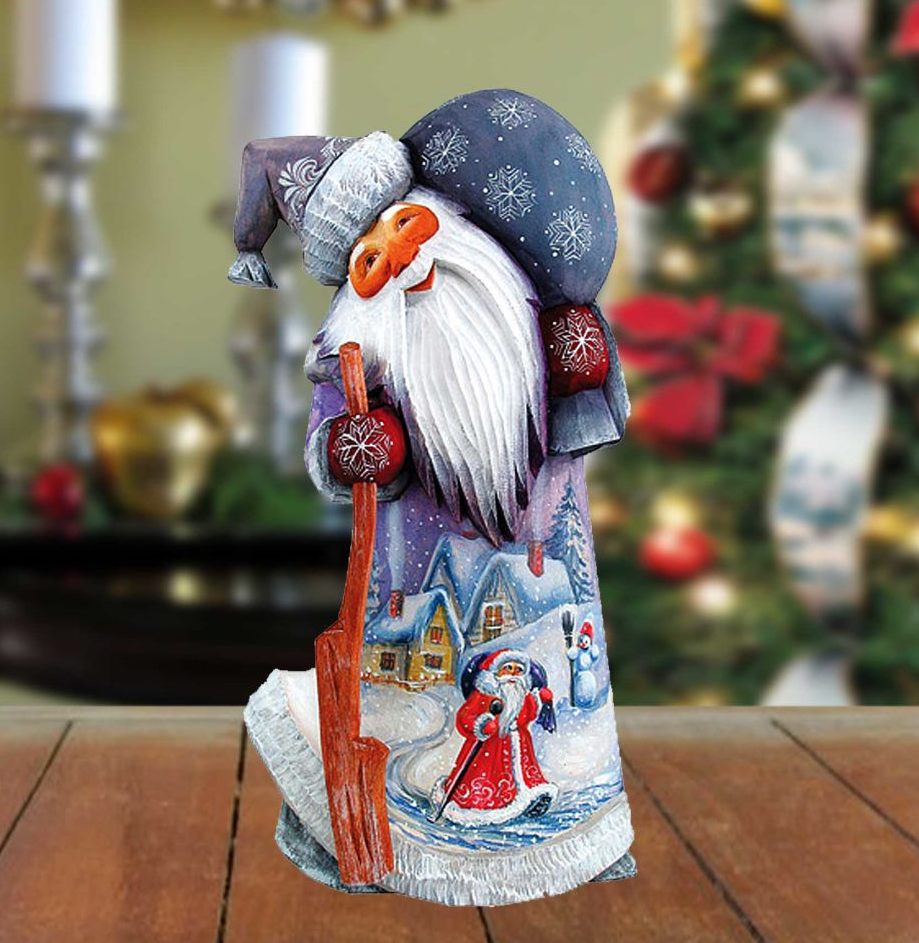 A colorful, hand-painted Christmas ornament depicting a Santa Claus figure with a snowman and other winter-themed elements.