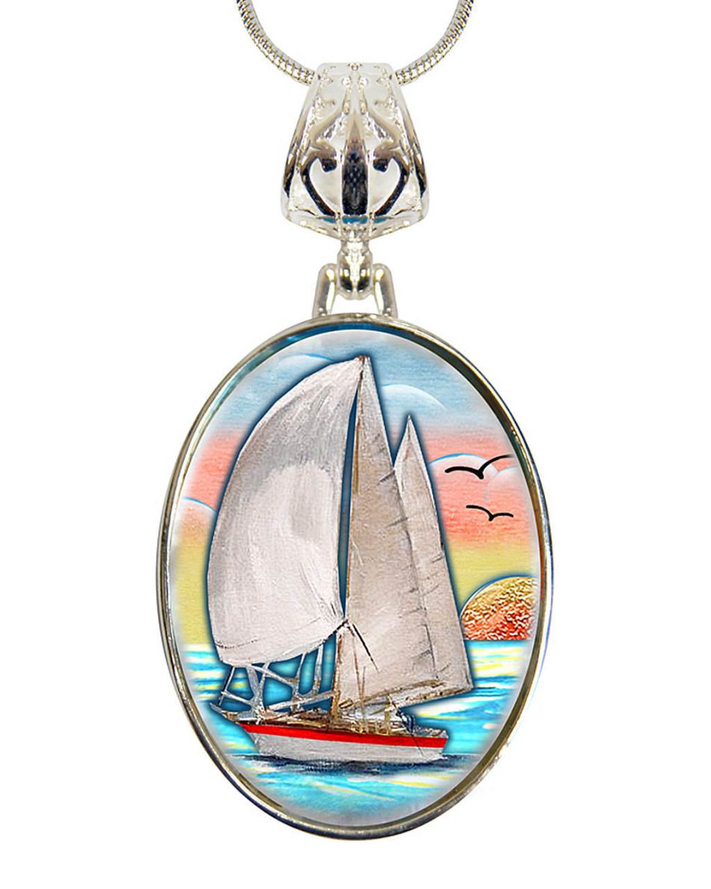 A pendant necklace with a circular oval-shaped design featuring a sailboat on the water, with a sunset in the background.