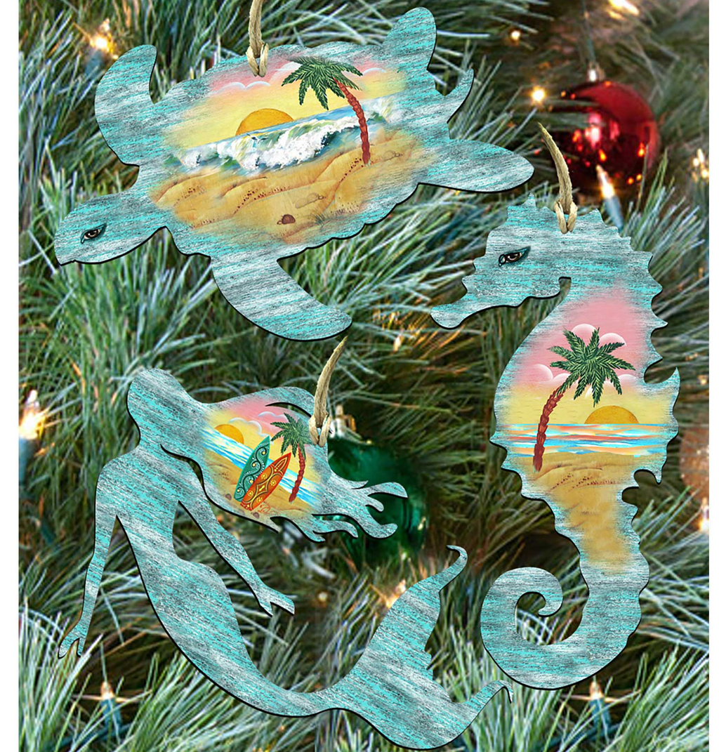 A collection of three ornaments shaped like sea creatures, including a turtle, a mermaid, and a seahorse, are displayed on a Christmas tree.