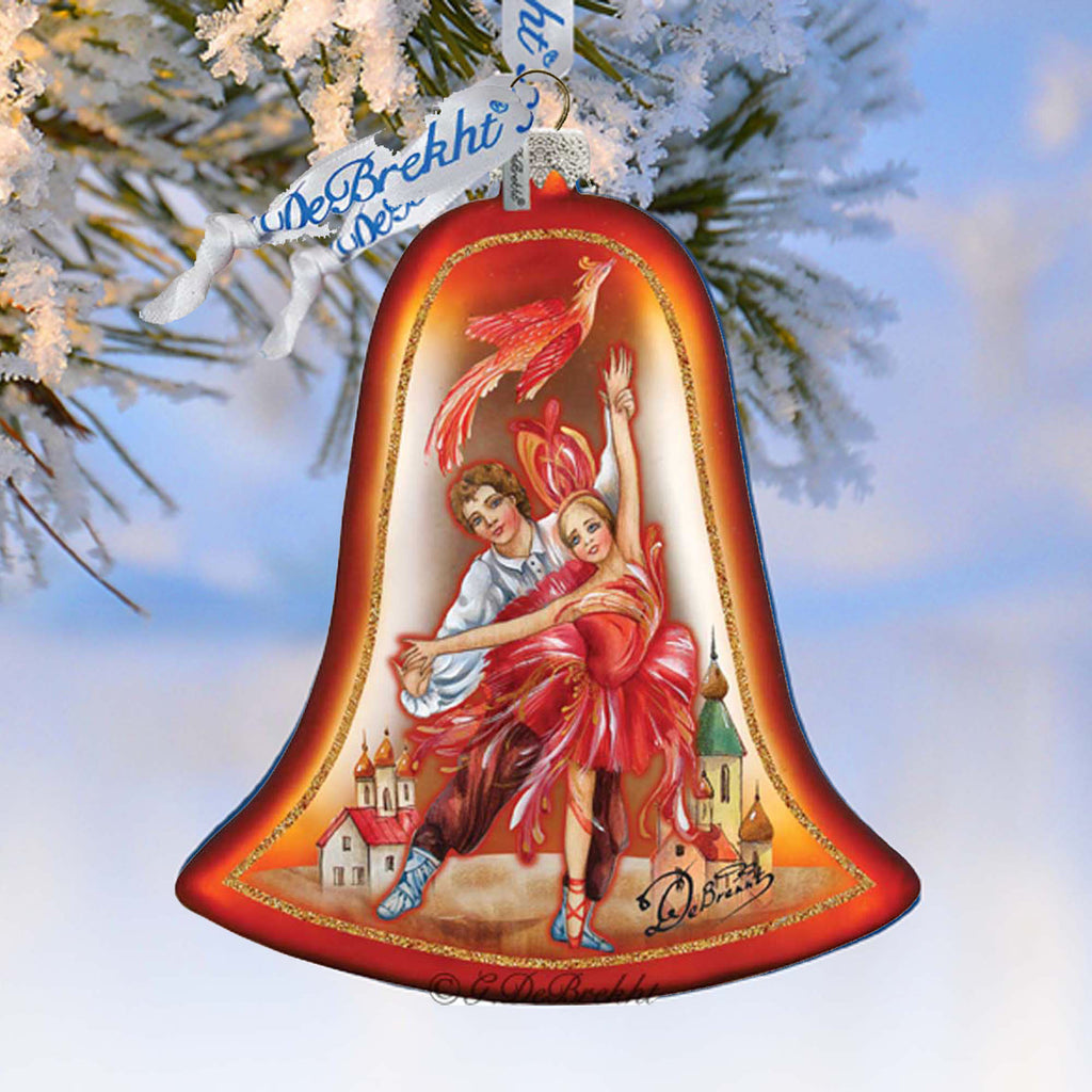 A decorative bell ornament featuring a painting of a couple dancing, with a snowy background and a castle in the distance.