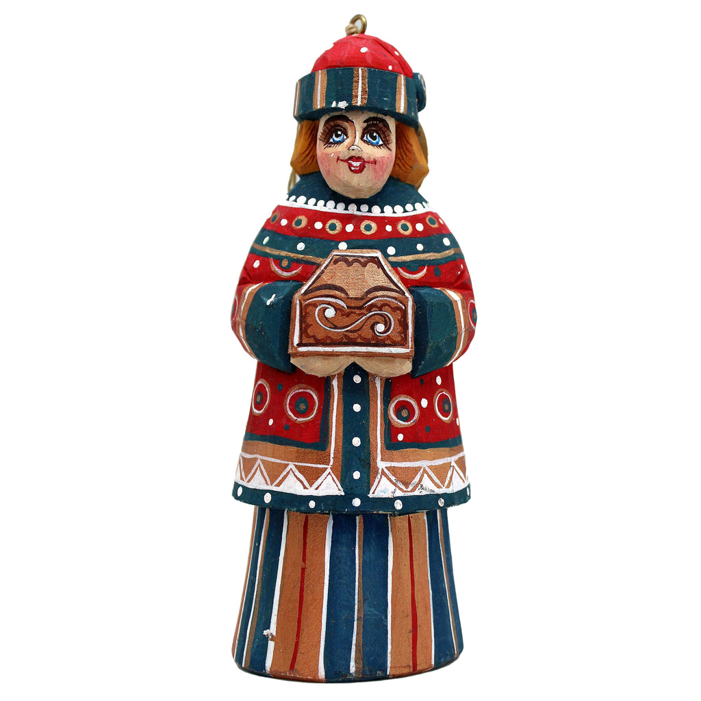 A colorful wooden figurine depicting a woman wearing a red hat and holding a brown object.