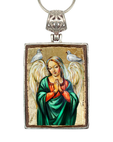 a pendant with a religious painting of a woman with wings, surrounded by two white birds.