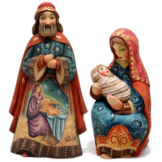 two figurines, one depicting a man and a woman, and the other depicting a baby.