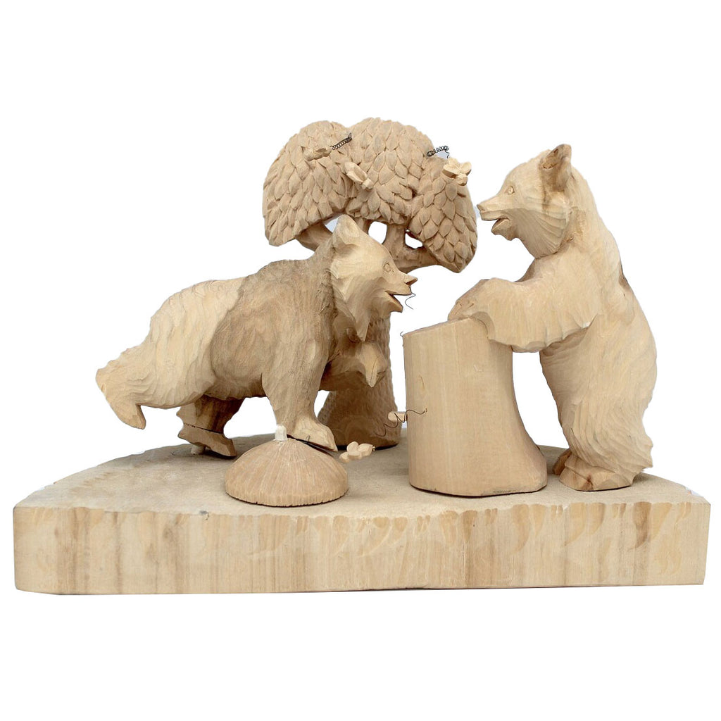 A wooden sculpture depicting three bears interacting with a tree trunk.