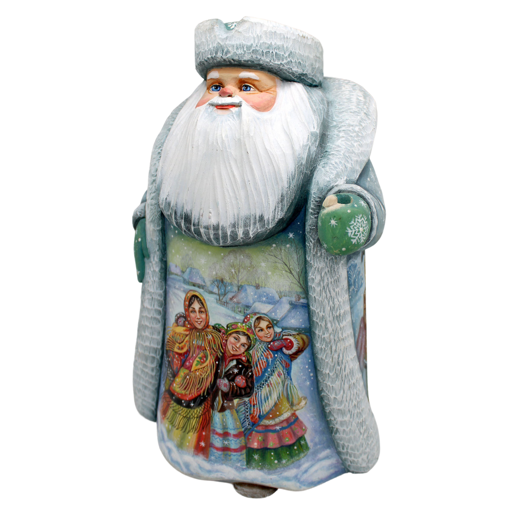 A ceramic Santa Claus figurine with a white beard and hat, wearing traditional clothing and holding a green ornament.