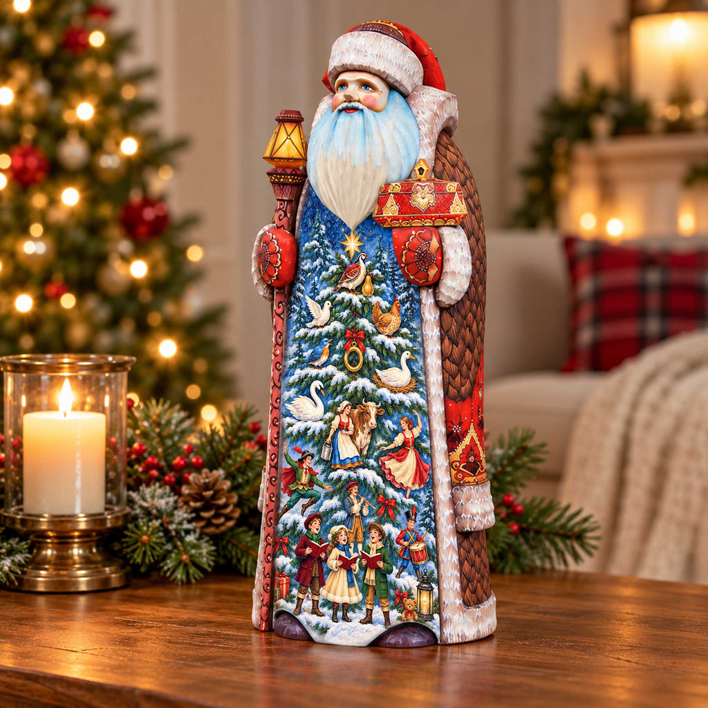 A colorful and detailed ceramic Santa Claus figurine is displayed on a wooden surface, surrounded by holiday decorations such as pine cones, berries, and a lit candle.