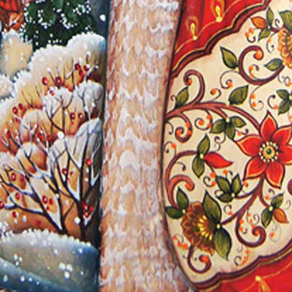 a close-up view of a decorative fabric with a floral pattern, including a red flower and green leaves. The fabric appears to be a piece of clothing or textile, possibly a shawl or a blanket. The image is a close-up of the fabric, showcasing its intricate design and vibrant colors.