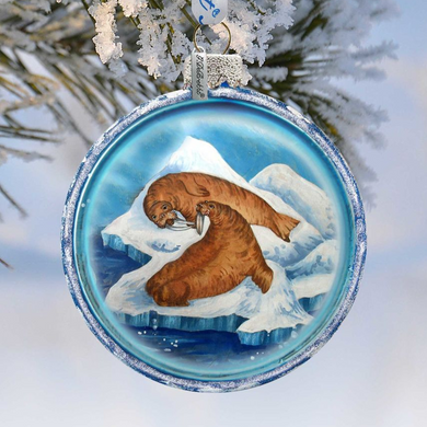 A round ornament featuring two walruses on an ice floe, with a snowy background.