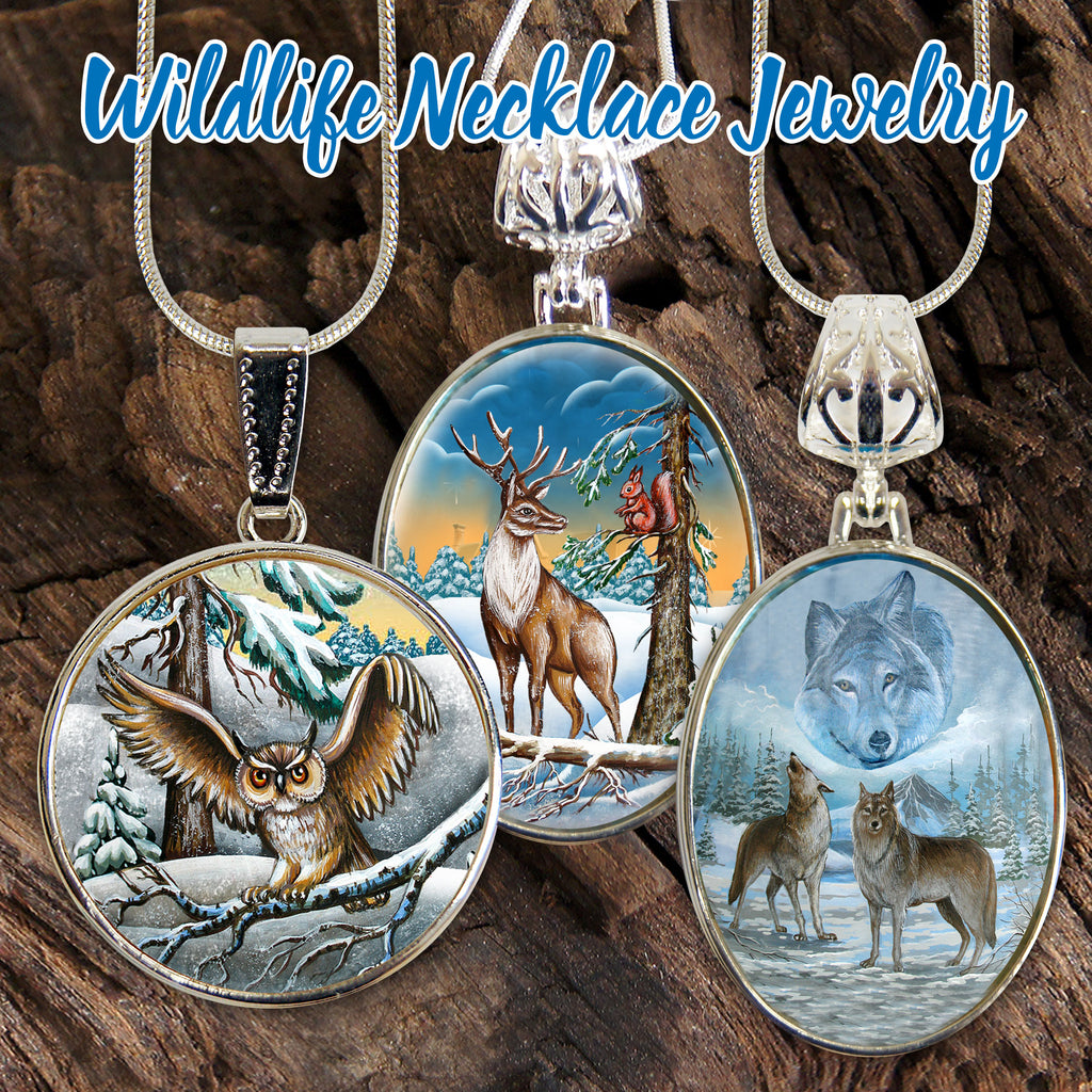 three pendants featuring wildlife scenes, including an owl, a deer, and a wolf, suspended from a chain against a natural background.