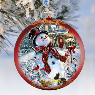 A red Christmas ornament with a snowman, birds, and a wreath, set against a snowy background.