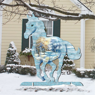 A wooden horse sculpture stands in a snowy landscape, with a house and trees visible in the background.
