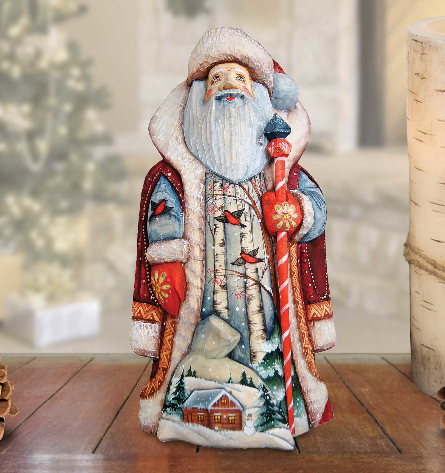 A hand-painted Santa Claus figurine with a long red pole and a red and white striped hat, standing on a wooden surface.