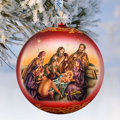 A red Christmas ornament with a nativity scene depicting the birth of Jesus Christ, surrounded by the Virgin Mary, Joseph, and baby Jesus.