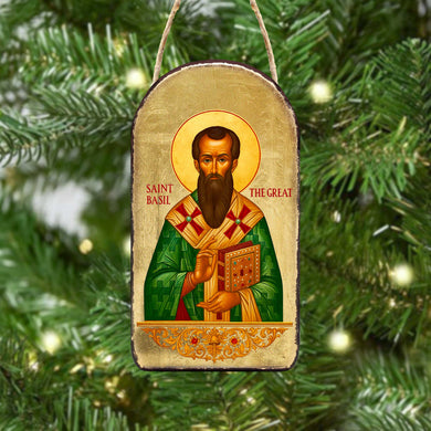 a religious icon of Saint Basil, a saint from the Orthodox Christian tradition, hanging on a Christmas tree.
