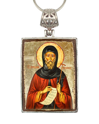 a religious icon of a bearded man wearing a red robe and holding a scroll, with a halo above his head.