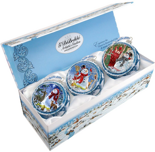 A set of three decorative Christmas ornaments in a blue box, each featuring a different winter scene.