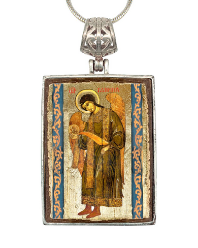 a rectangular pendant with an ornate design and a religious icon of an angel.