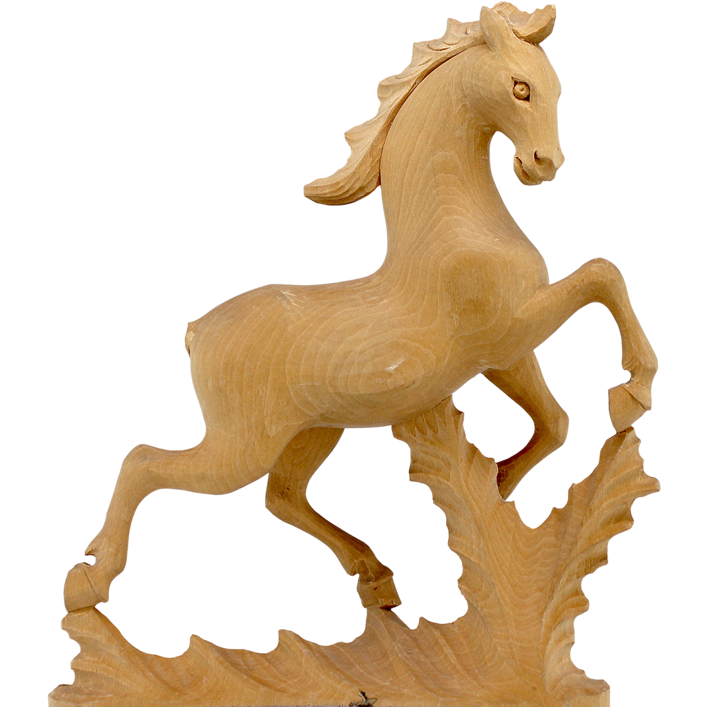 A wooden sculpture of a horse in mid-gallop, with a flowing mane and tail, set against a plain background.