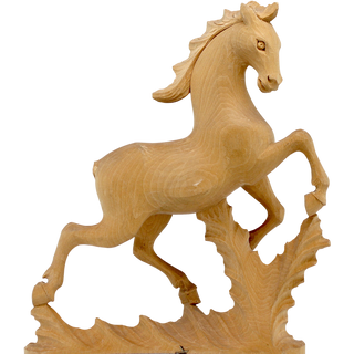 A wooden sculpture of a horse in mid-gallop, with a flowing mane and tail, set against a plain background.