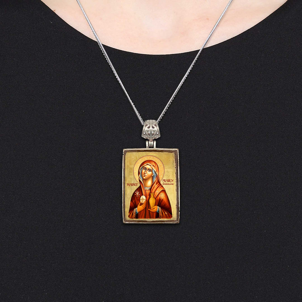 A necklace with a religious icon pendant, which appears to be a depiction of a saint or religious figure.
