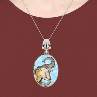 A necklace with a pendant featuring an elephant and a cloud.