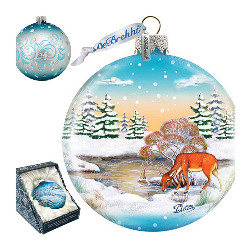 a christmas ornament with a deer in the snow
