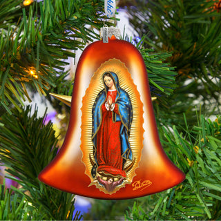 A red bell ornament with a depiction of the Virgin Mary is hanging on a Christmas tree.