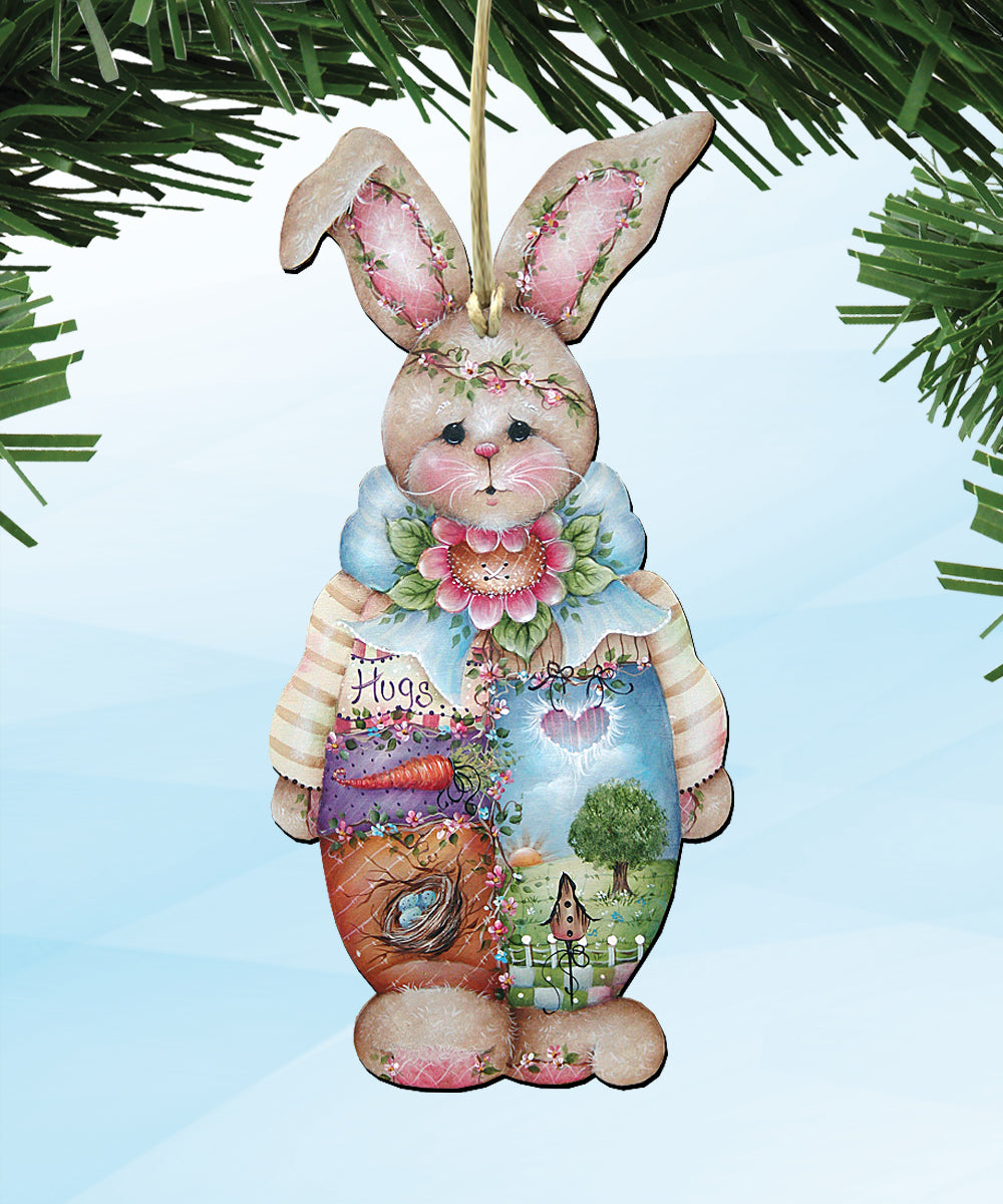 A wooden ornament in the shape of a bunny, decorated with various elements such as flowers, leaves, and a heart.