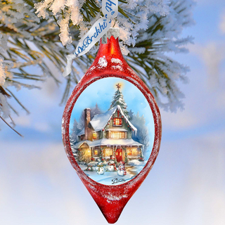 A red Christmas ornament with a winter scene inside, featuring a snowy house, a Christmas tree, and snowmen.