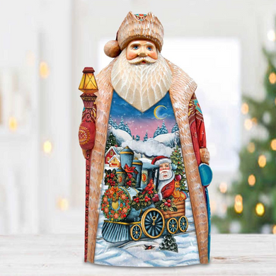 A wooden Santa Claus figurine holding a lantern and standing next to a Christmas tree.