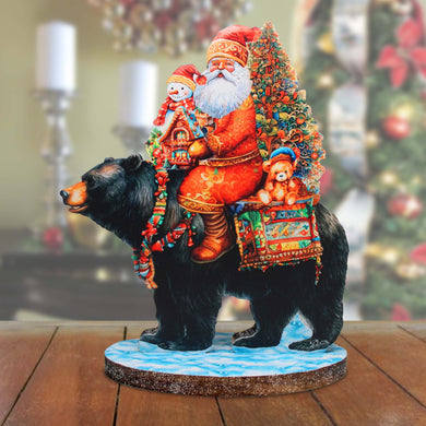 a statue of santa riding a bear on a table