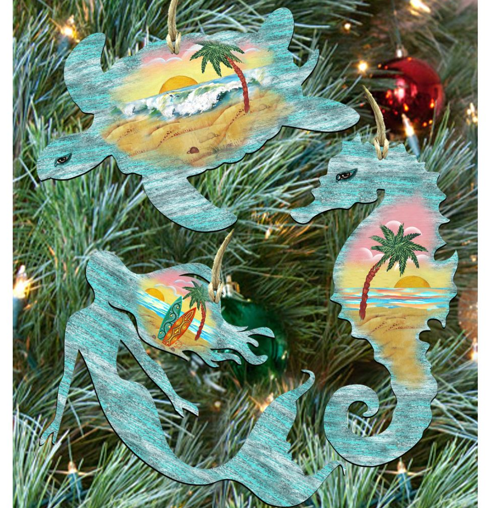 a collection of three ornaments hanging on a Christmas tree, each depicting a different tropical scene.